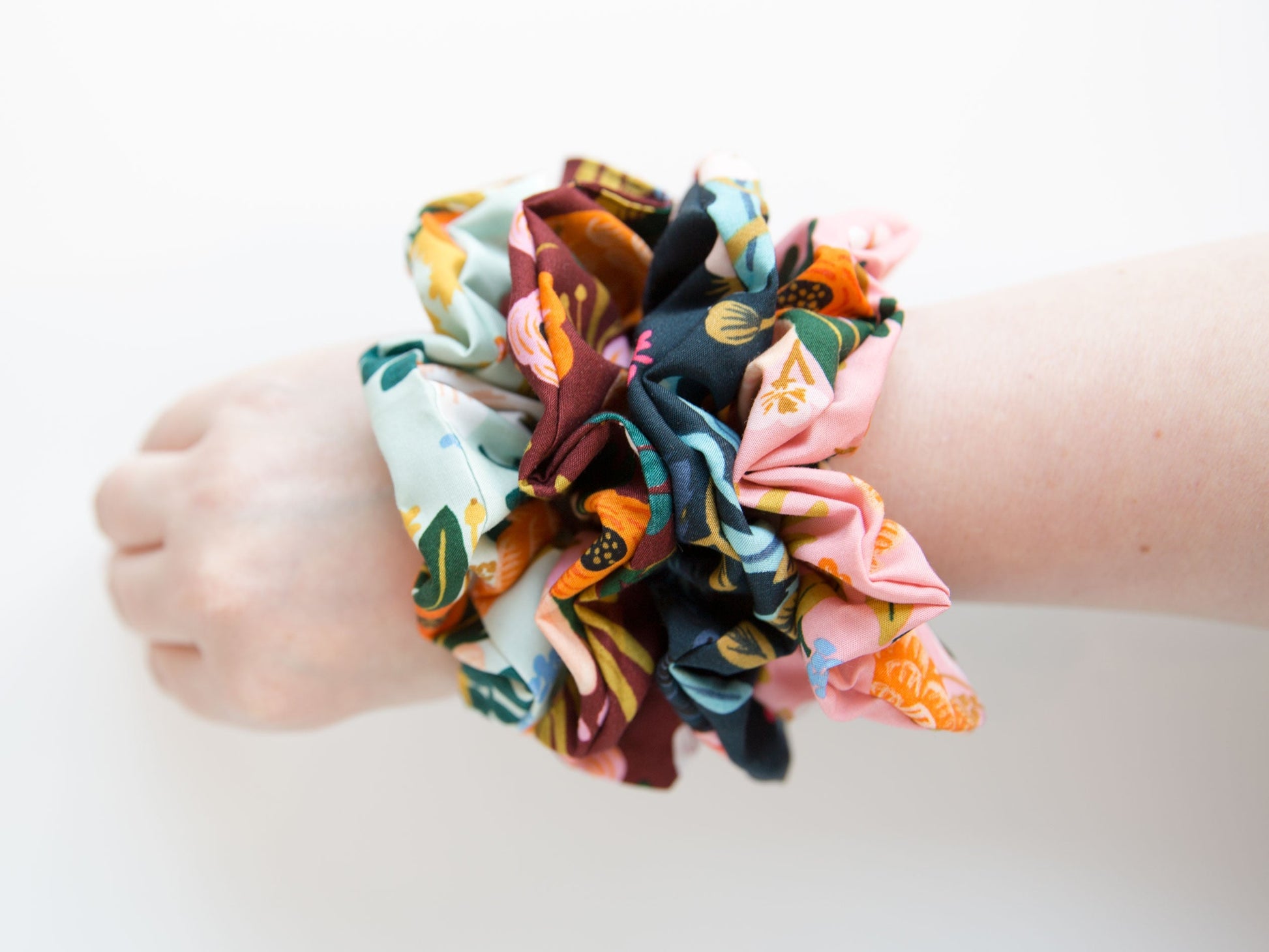 Several scrunchies on a wrist