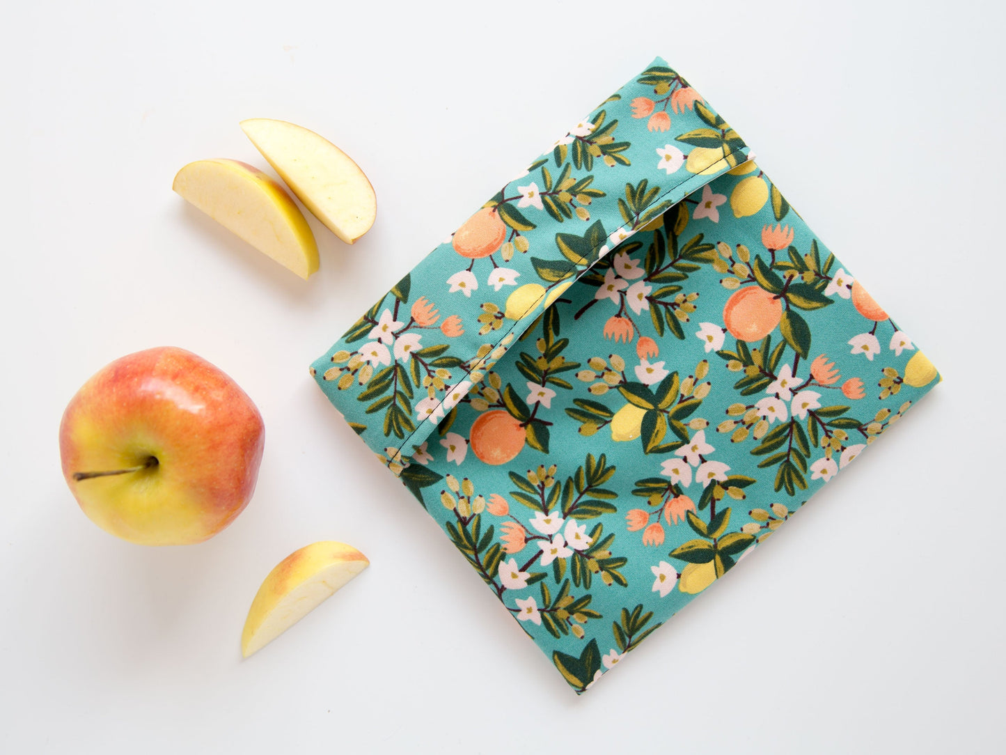 teal snack bag with oranges and lemons on it.