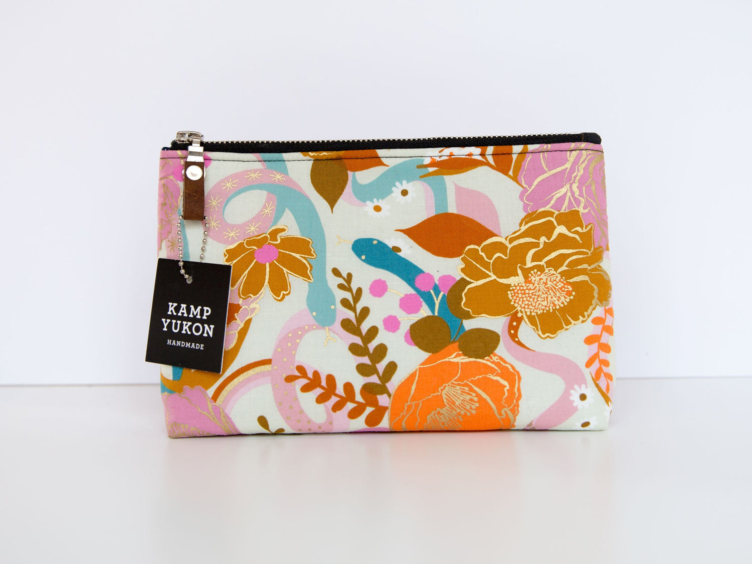 zipper pouch with snakes and flowers on it.