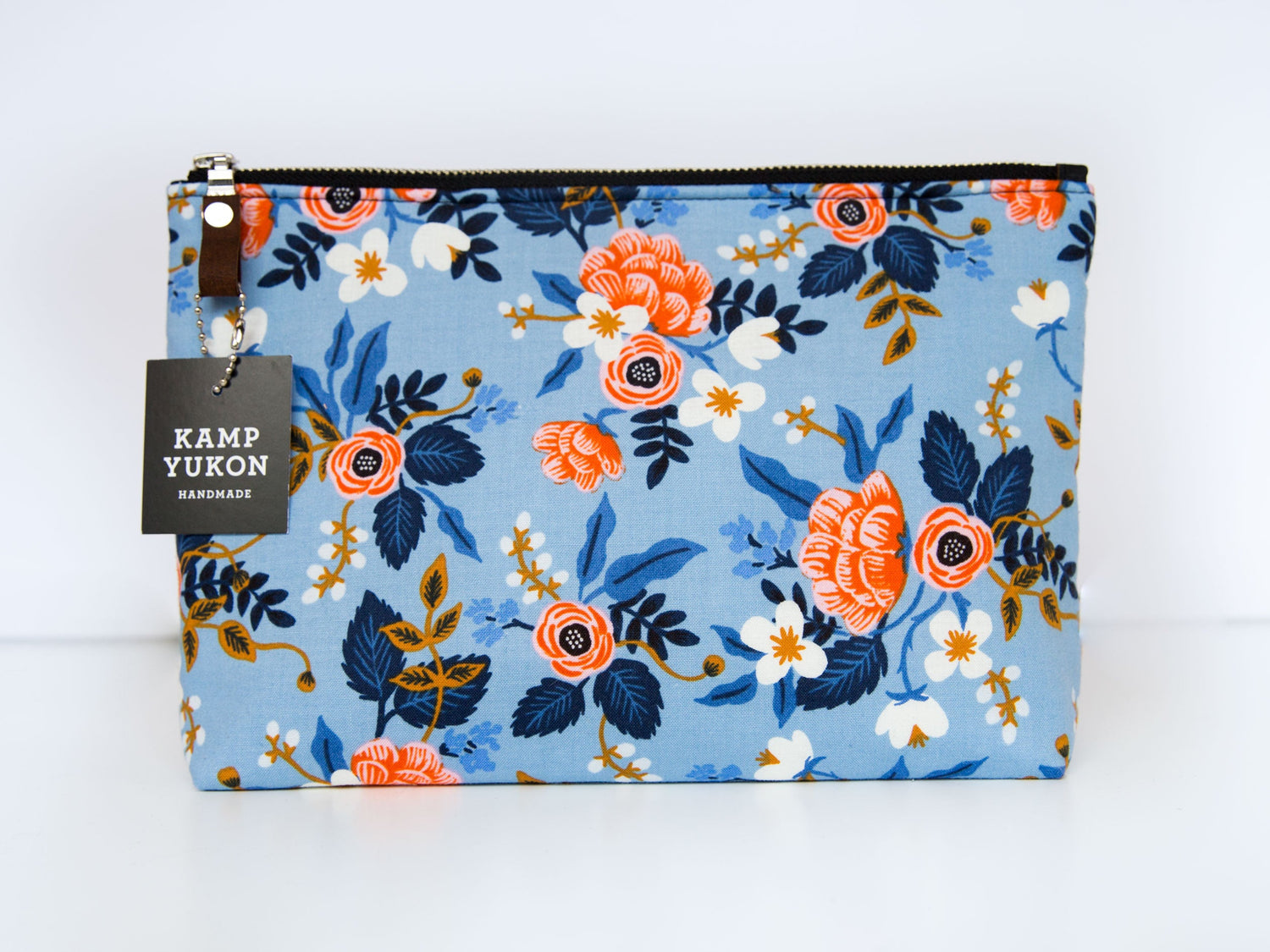 Zipper pouch with pink flowers on a light blue background