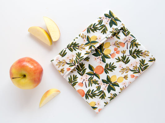 cream snack bag with oranges and lemons on it.