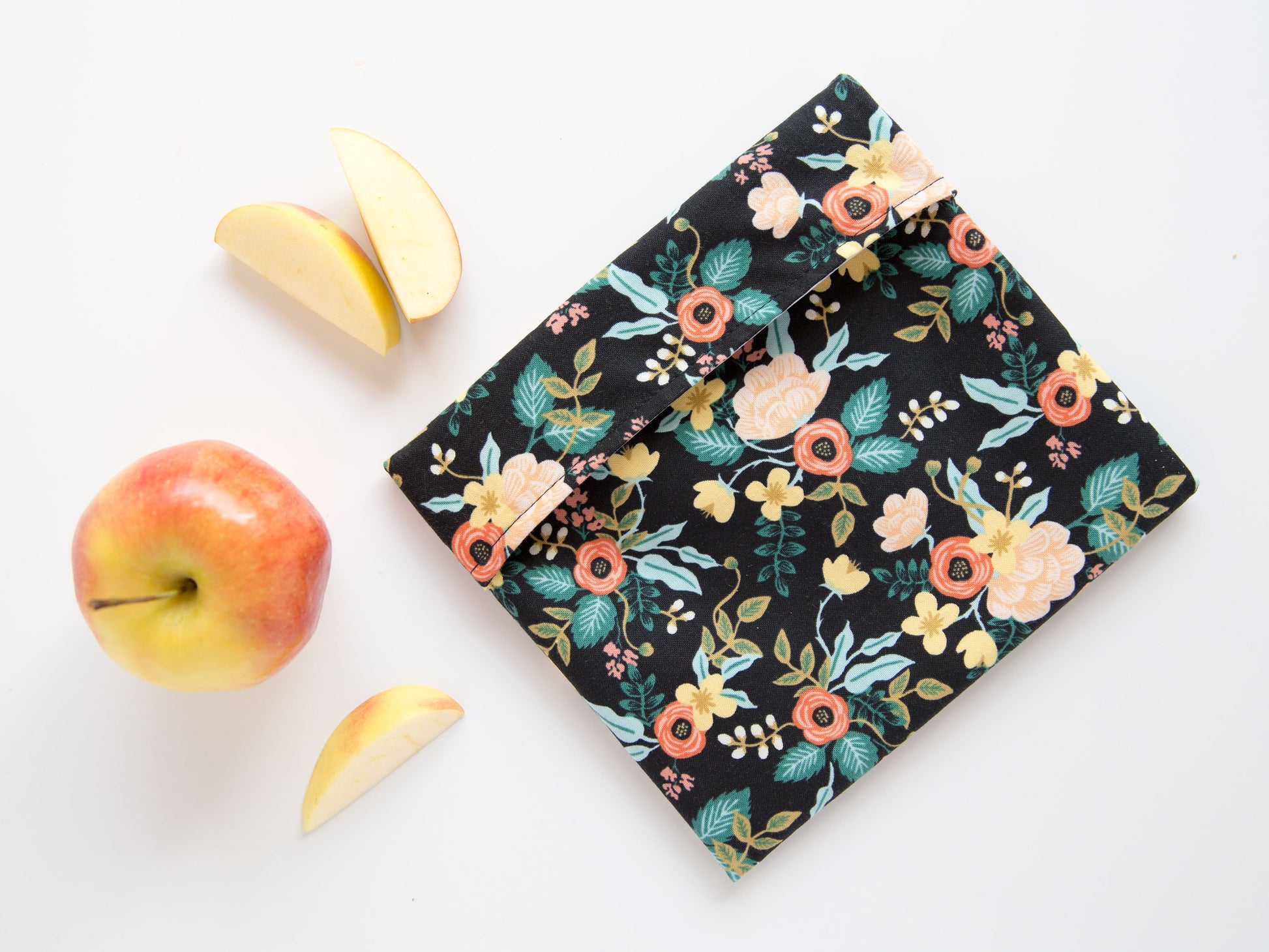 black snack bag with pink and yellow flowers