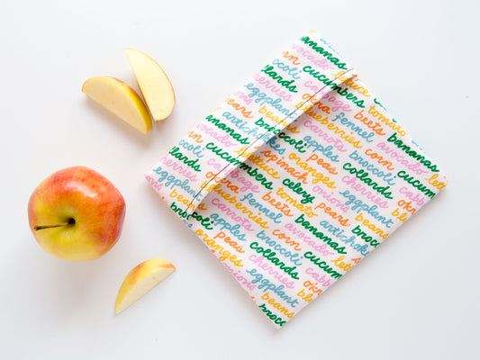 snack bag with cursive writing on it saying different fruits and vegetables