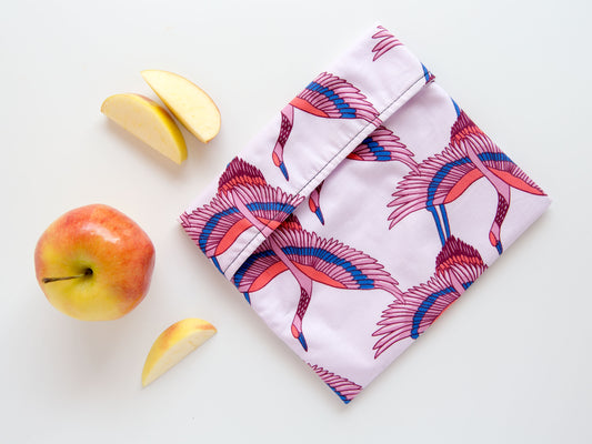 light pink snack bag with retro looking cranes on it.