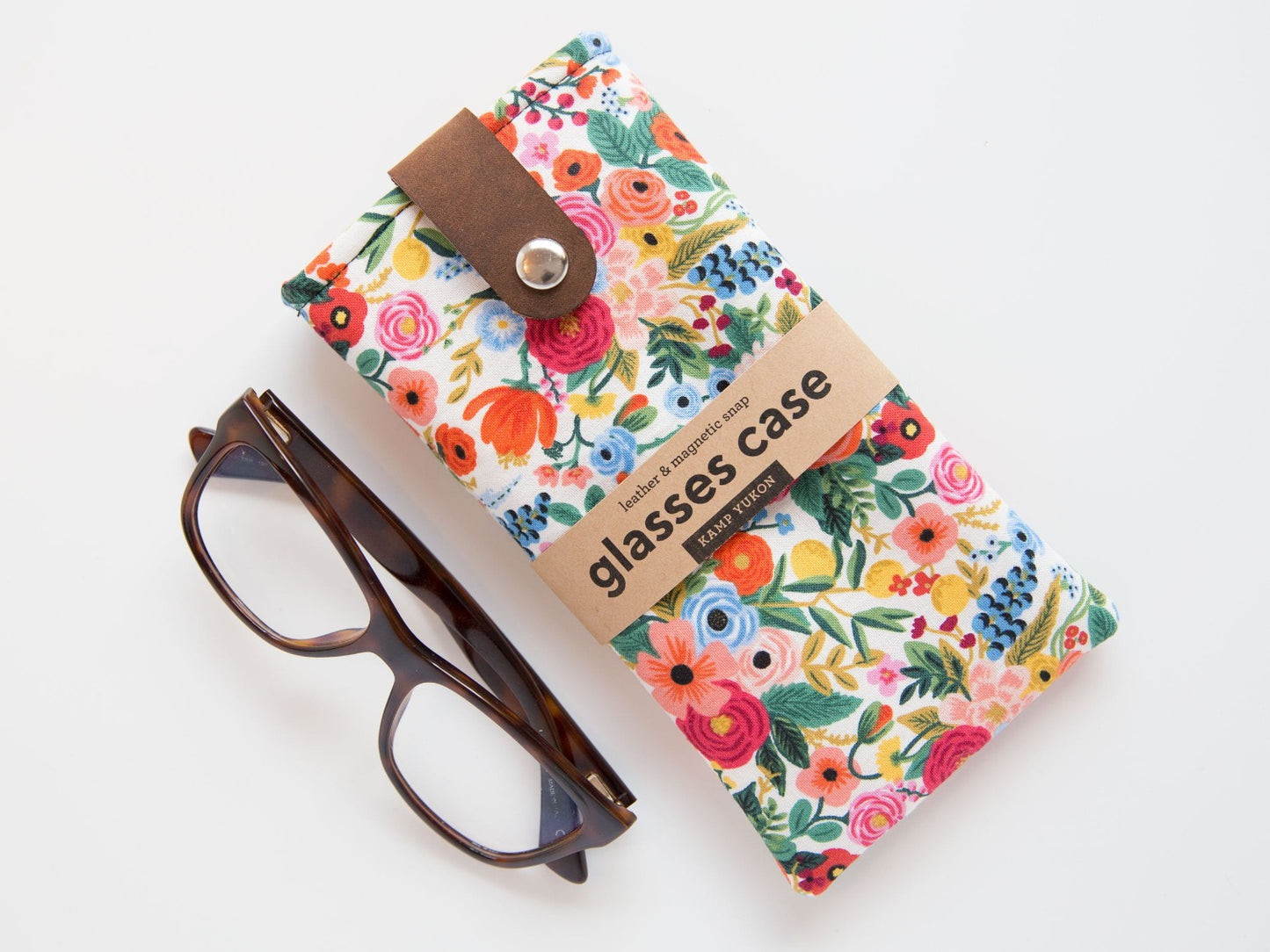 reading glasses beside a floral glasses case