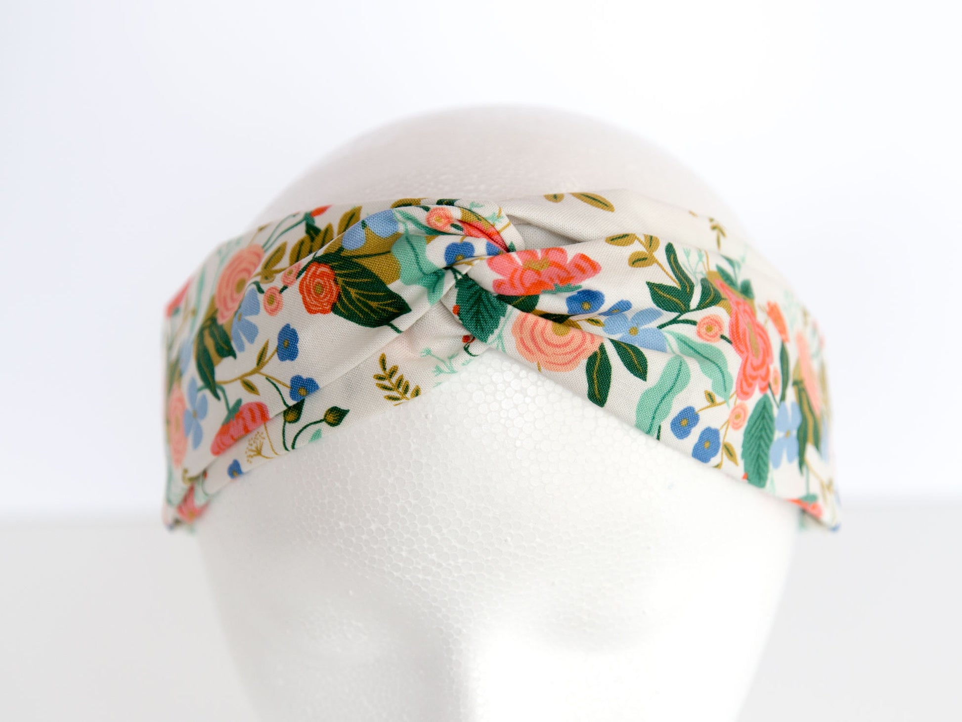 white rifle paper floral headband on a mannequin