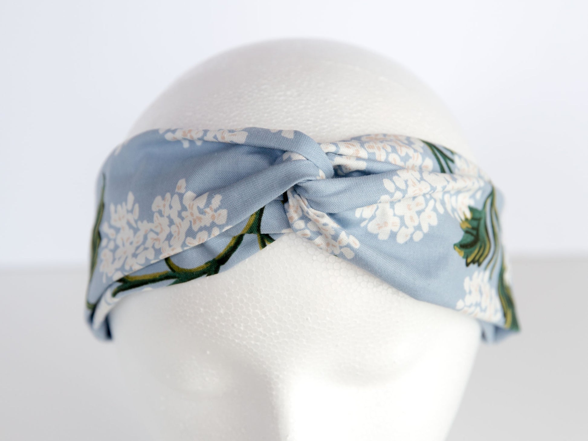 blue rifle paper floral headband on a mannequin