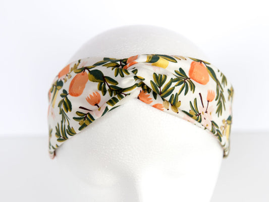 white rifle paper headband on a mannequin with leaves and citrus fruit