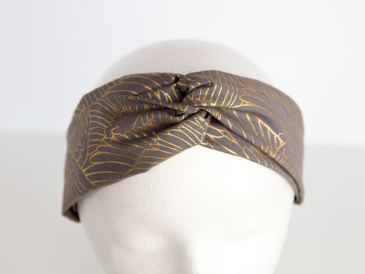 grey and gold headband on a mannequin