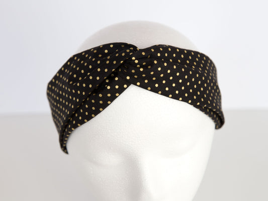 black headband with gold dots on a mannequin