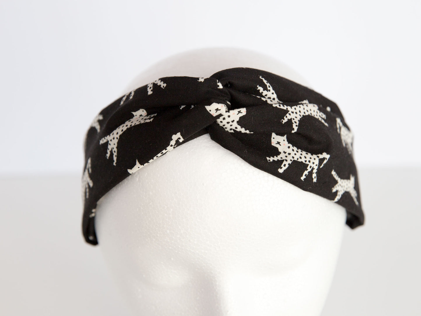 black headband with kitties on it, on a mannequin