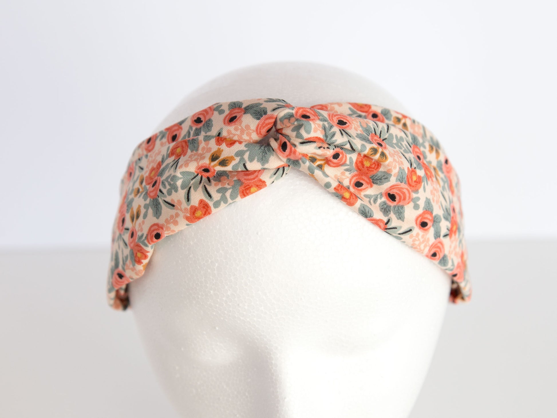 pink rifle paper floral headband on a mannequin